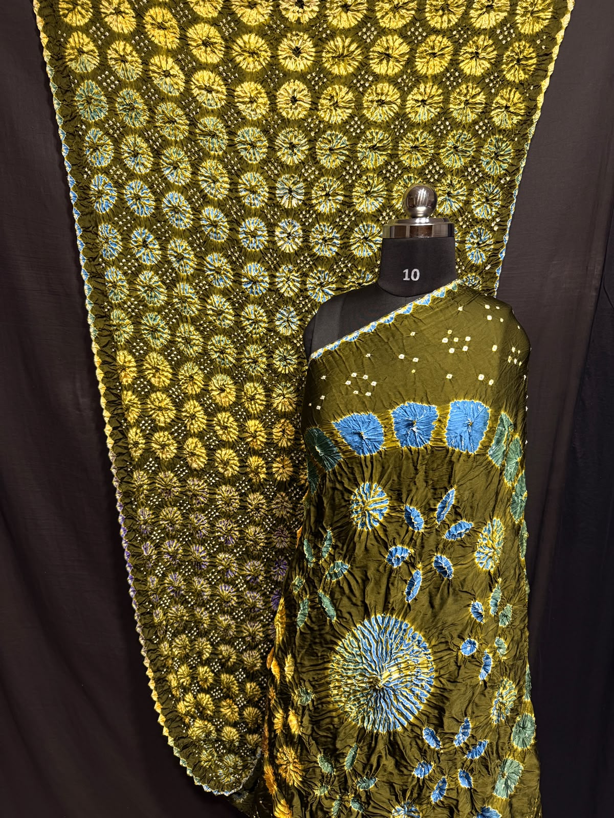 ## Sibori with Bandhej Saree ##
**Fabric**: Modal Silk
- Multi Sibori design
- Handcrafted item
**Description**:
- **Length**: 6.50 meters
- **Width**: 44-46 inches
- **Wash Care**: Dry clean only