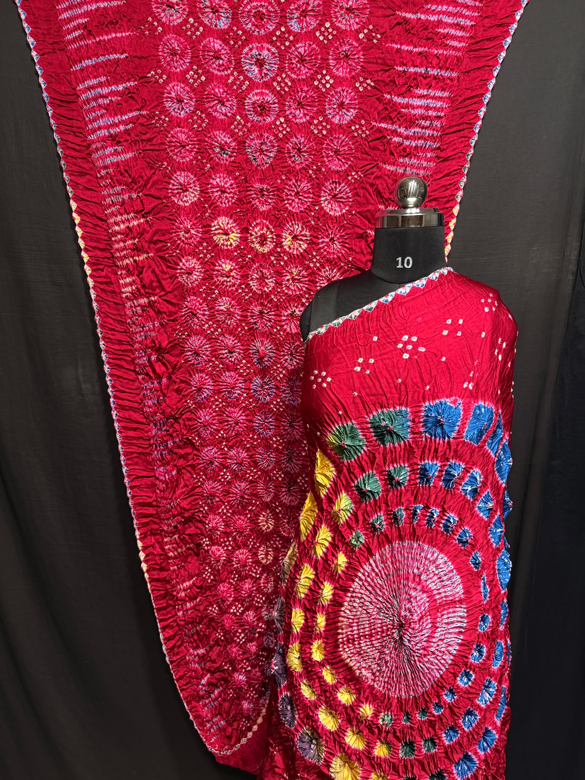 ## Sibori with Bandhej Saree ##
**Fabric**: Modal Silk
- Multi Sibori design
- Handcrafted item
**Description**:
- **Length**: 6.50 meters
- **Width**: 44-46 inches
- **Wash Care**: Dry clean only