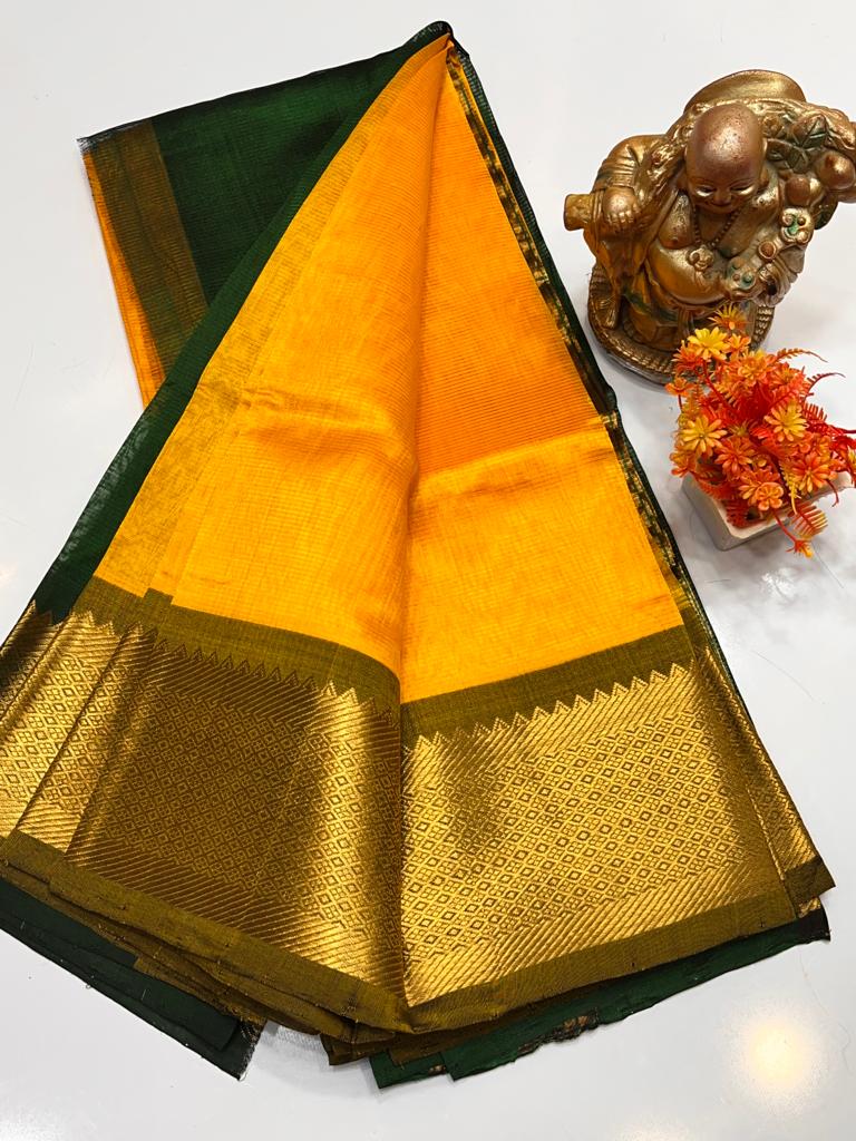 The Golden Yellow color with contrast Pink border in pattu Gadwal silk Saree