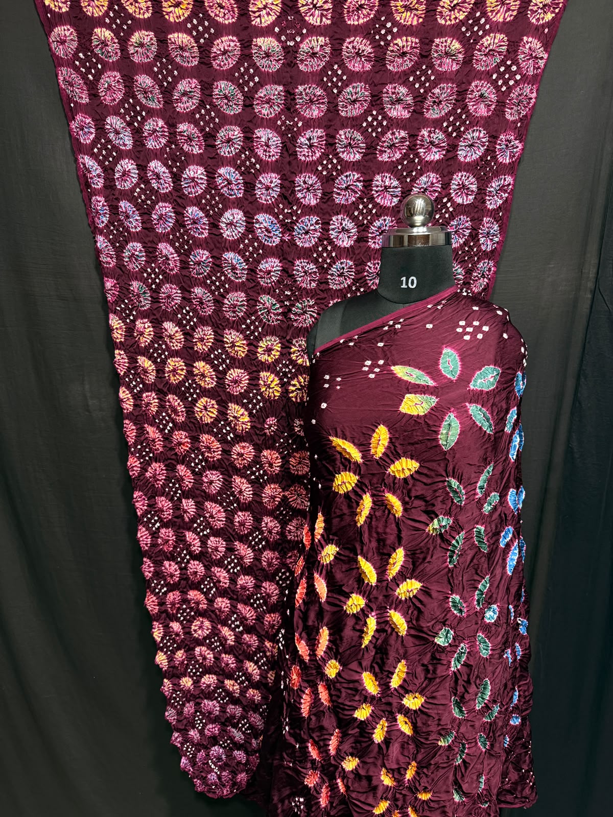 ## Sibori with Bandhej Saree ##
**Fabric**: Modal Silk
- Multi Sibori design
- Handcrafted item
**Description**:
- **Length**: 6.50 meters
- **Width**: 44-46 inches
- **Wash Care**: Dry clean only