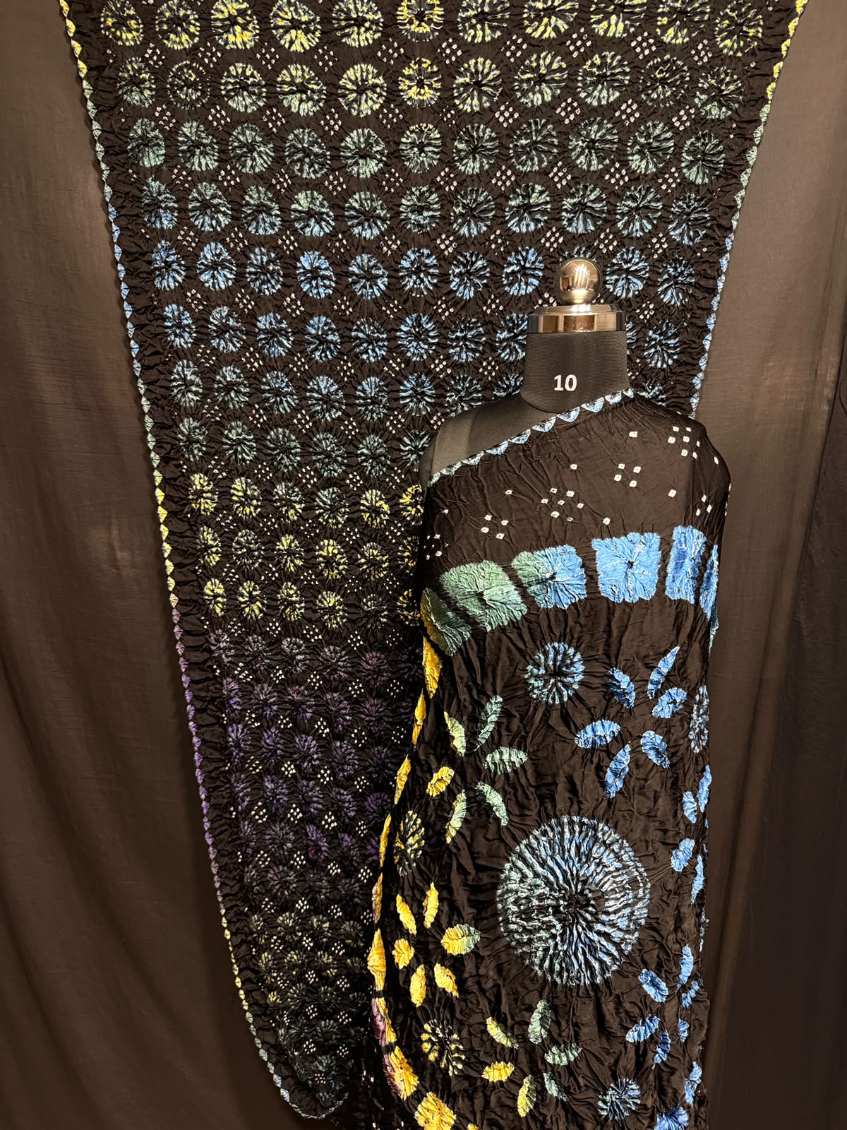 ## Sibori with Bandhej Saree ##
**Fabric**: Modal Silk
- Multi Sibori design
- Handcrafted item
**Description**:
- **Length**: 6.50 meters
- **Width**: 44-46 inches
- **Wash Care**: Dry clean only