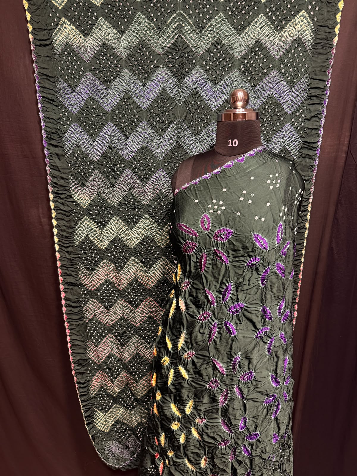 ## Sibori with Bandhej Saree ##
**Fabric**: Modal Silk
- Multi Sibori design
- Handcrafted item
**Description**:
- **Length**: 6.50 meters
- **Width**: 44-46 inches
- **Wash Care**: Dry clean only