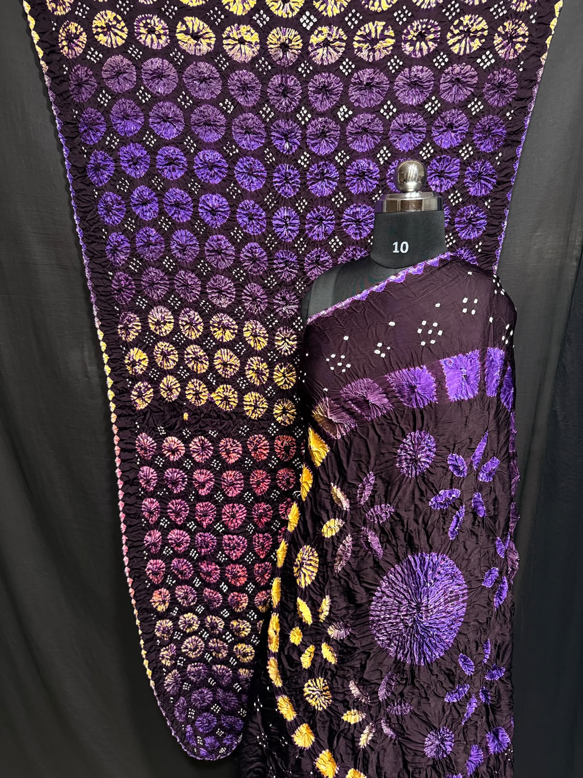 ## Sibori with Bandhej Saree ##
**Fabric**: Modal Silk
- Multi Sibori design
- Handcrafted item
**Description**:
- **Length**: 6.50 meters
- **Width**: 44-46 inches
- **Wash Care**: Dry clean only