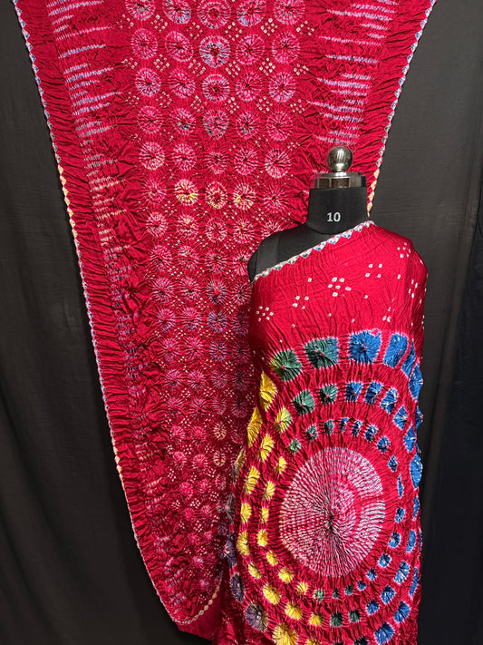 ## Sibori with Bandhej Saree ##
**Fabric**: Modal Silk
- Multi Sibori design
- Handcrafted item
**Description**:
- **Length**: 6.50 meters
- **Width**: 44-46 inches
- **Wash Care**: Dry clean only