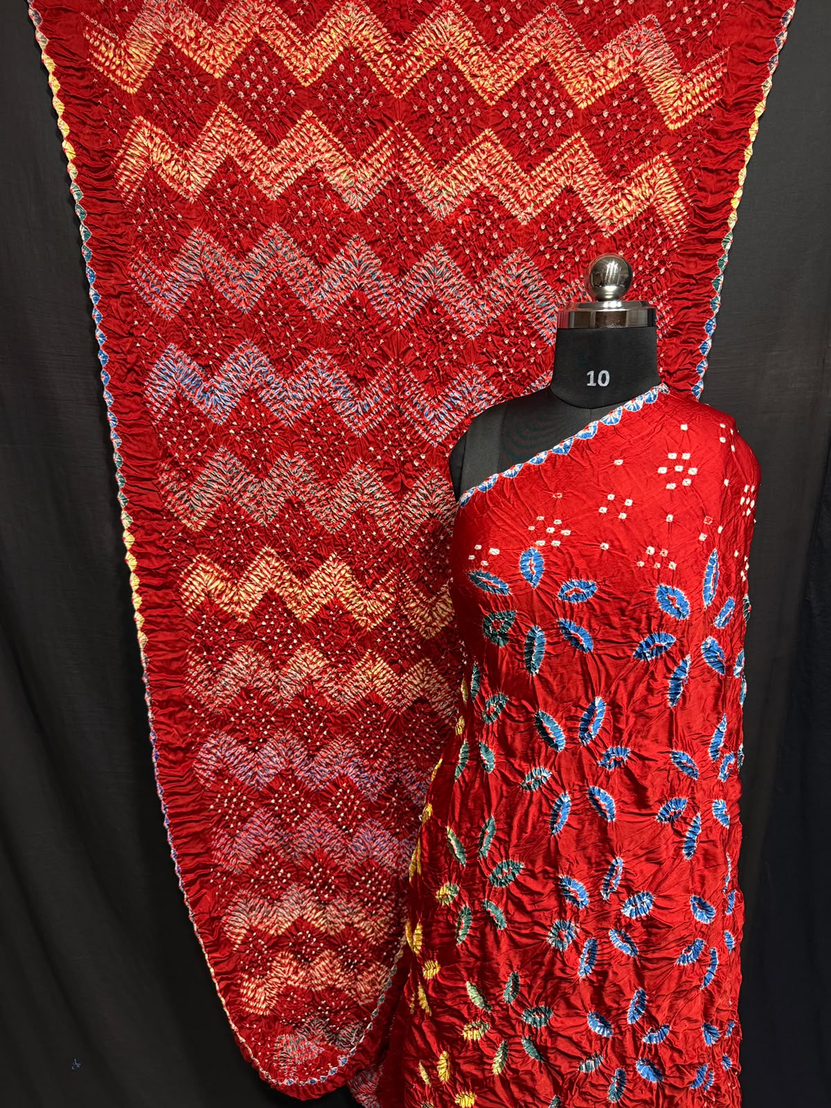 ## Sibori with Bandhej Saree ##
**Fabric**: Modal Silk
- Multi Sibori design
- Handcrafted item
**Description**:
- **Length**: 6.50 meters
- **Width**: 44-46 inches
- **Wash Care**: Dry clean only